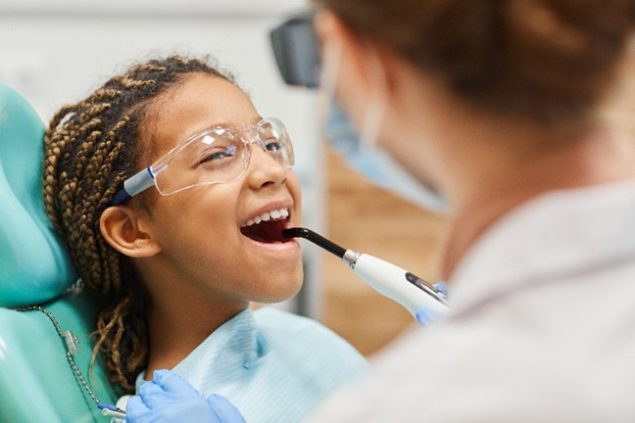 Image of child at dentist getting sealants