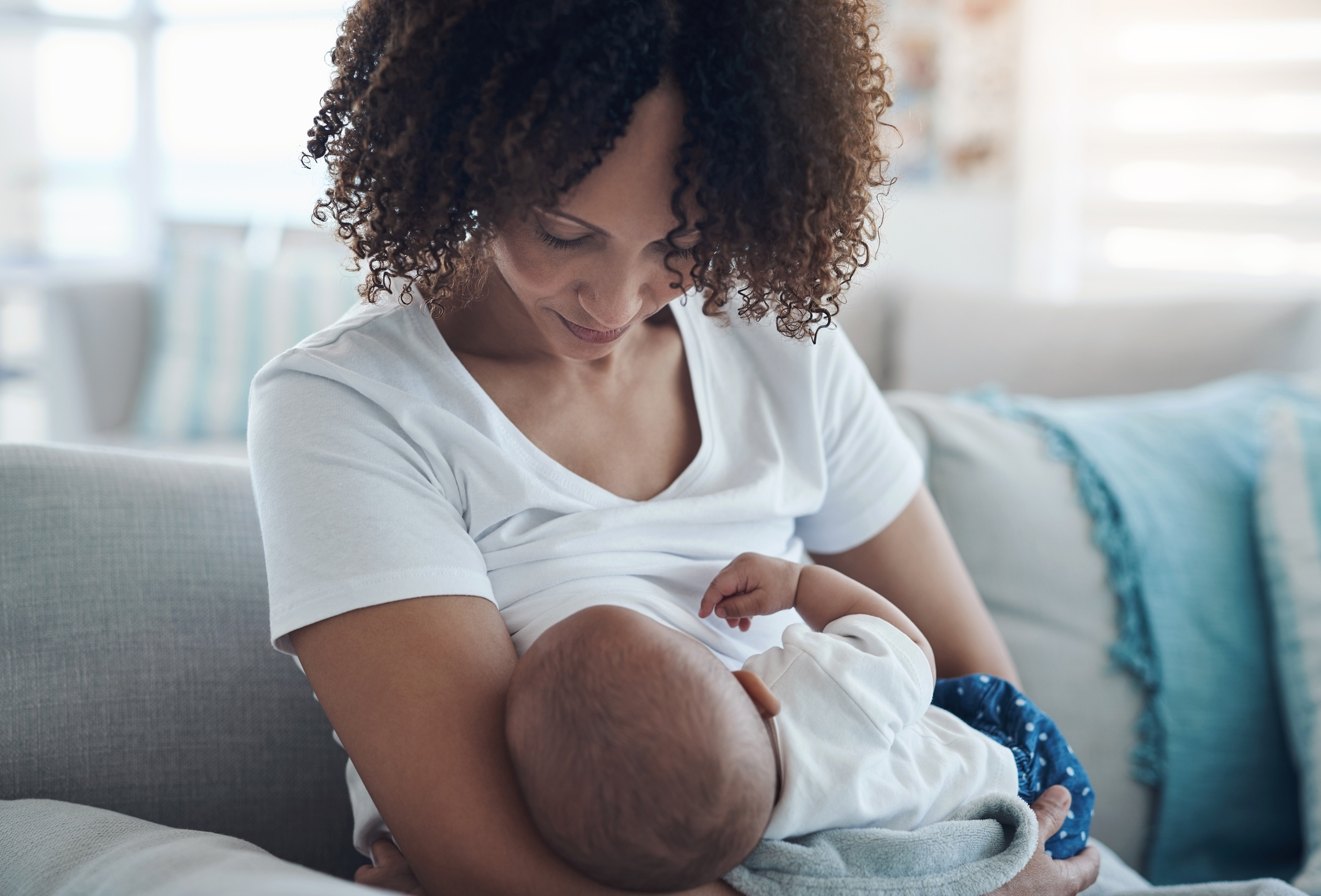 Image of woman breastfeeding on couch