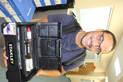 DOH employee holding toolbox of pool test kit equipment