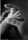 Women holding baby's foot