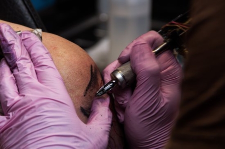 Image of person getting tattooed.