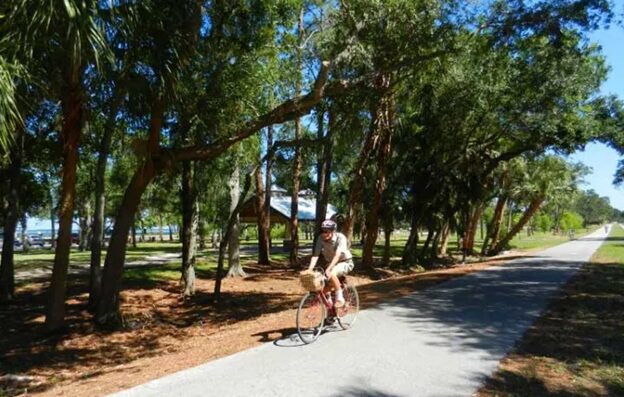 person biking on park trail