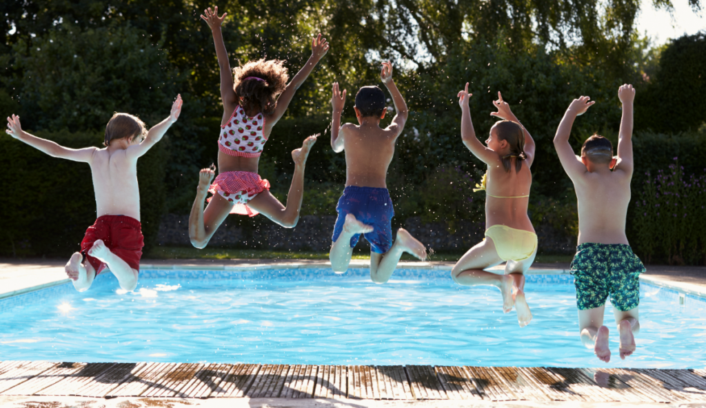 Image of 5 kids jumping into pool