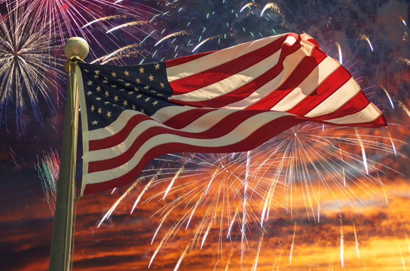Image of american flag with fireworks in background
