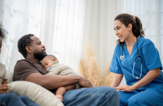 Father holding child at doctor
